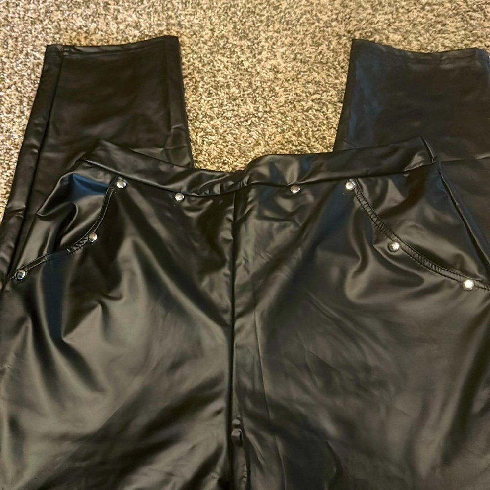 Black pleather pants that are tall length.